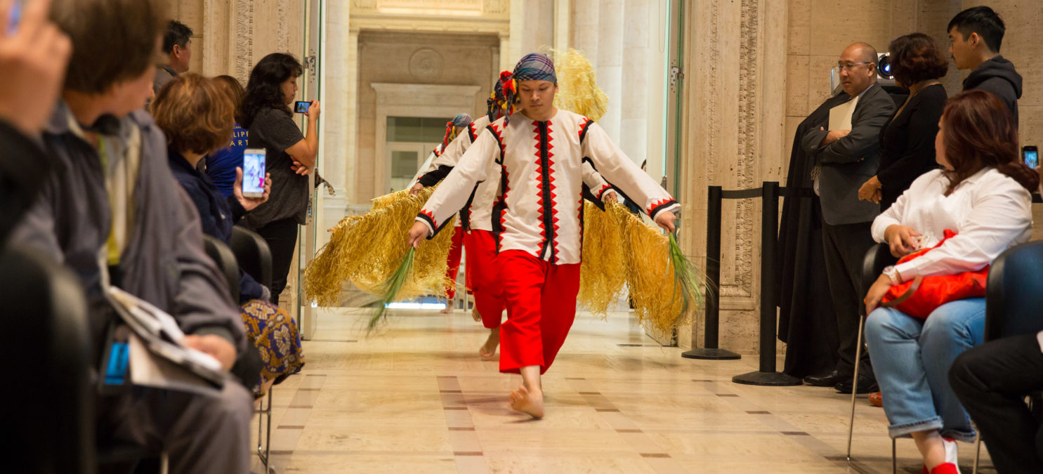 A line of performers proceeding down a center aisle